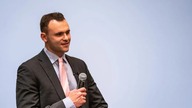 Aaron Golub holding microphone