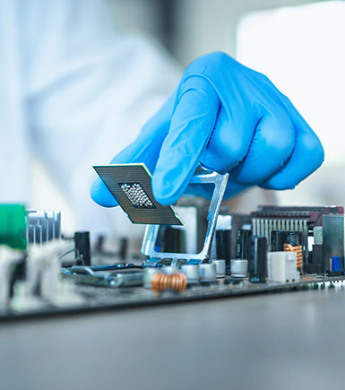 a close up of hand working on a machine processing board