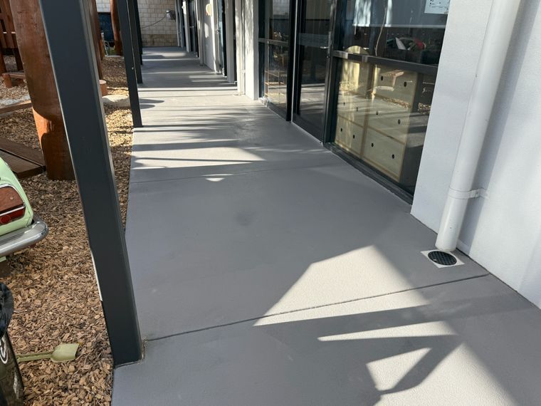 Grey colour-sealed concrete alfresco along a home