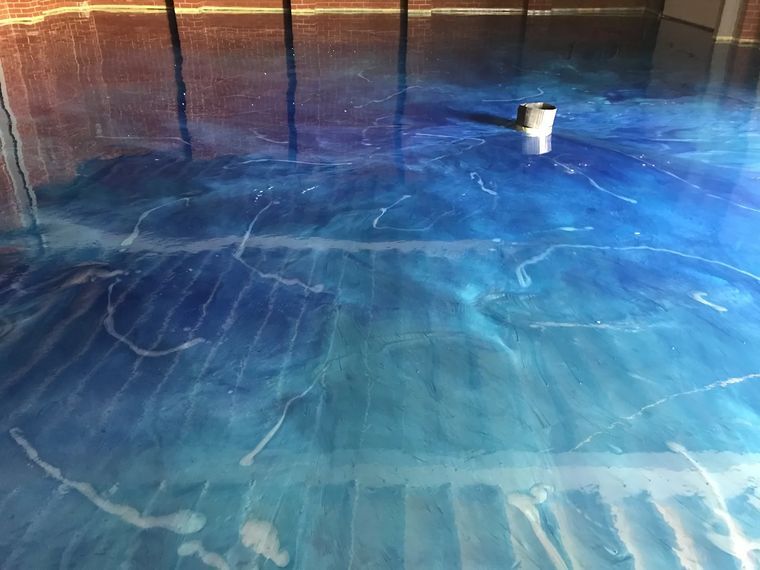 Blue metallic epoxy floor with a marbled finish